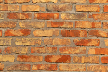 Old red brick wall background texture close up