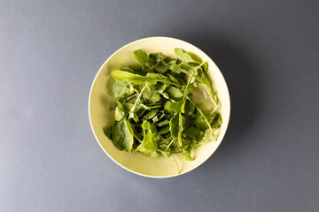 Overhead view of leaf vegetables in bowl on table