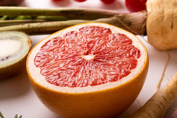 Close-up of fresh grapefruit halved amidst various food on table