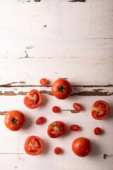 Naklejka na ściany i meble Directly view of fresh tomato variations on white wooden table