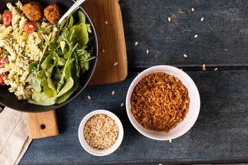 Directly above view of fresh italian meal in bowl on wooden table