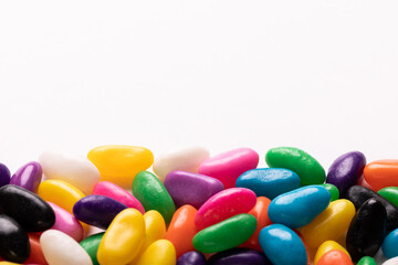 Close-up view of multi colored candies with copy space against white background
