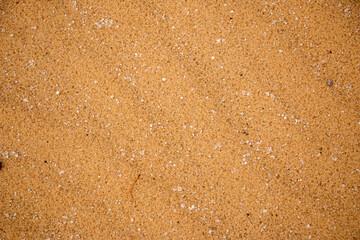 Textural sand, with  relief surface, multi-colored layers and different in size of granules, in outdoor sand career, after mining ore and sand for construction.
