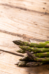 Close-up of raw green asparagus on wooden table
