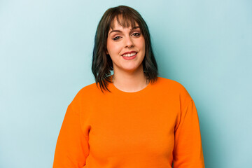 Obraz premium Young caucasian woman isolated on blue background happy, smiling and cheerful.