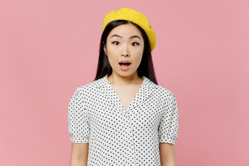 Young shocked surprised amazed woman of Asian ethnicity 20s wear white polka dot t-shirt yellow...
