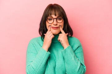 Young caucasian woman isolated on pink background doubting between two options.