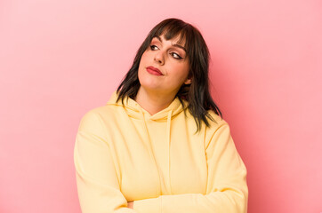 Fototapeta premium Young caucasian woman isolated on pink background dreaming of achieving goals and purposes