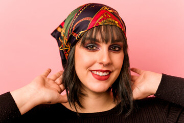 Young caucasian makeup artist woman isolated on pink background