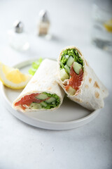 Healthy salmon wrap with fresh salad