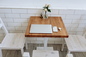 set of modern man gadgets on brown table. laptop, phone, watch, headphones. business