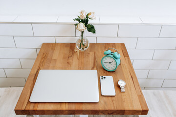 set of modern man gadgets on brown table. laptop, phone, watch, headphones. business