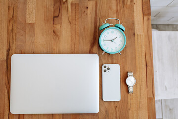 set of modern man gadgets on brown table. laptop, phone, watch, headphones. business