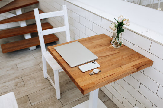 Set Of Modern Man Gadgets On Brown Table. Laptop, Phone, Watch, Headphones. Business