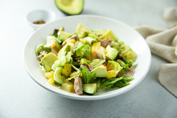 Healthy salad with duck, pineapple and avocado