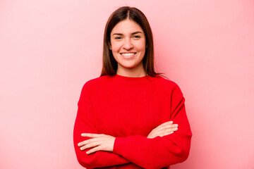 Obraz premium Young caucasian woman isolated on pink background who feels confident, crossing arms with determination.