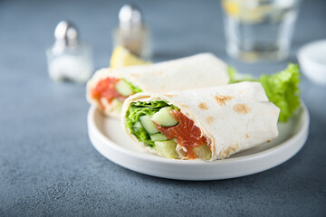Healthy salmon wrap with fresh salad