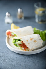 Healthy salmon wrap with fresh salad