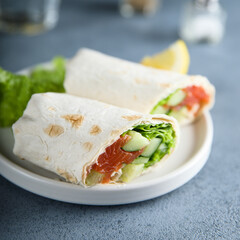 Healthy salmon wrap with fresh salad