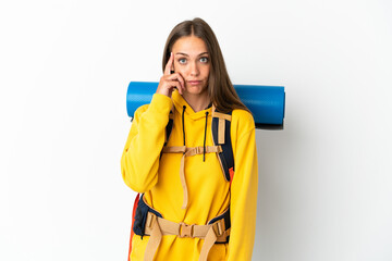 Young mountaineer woman with a big backpack over isolated white background thinking an idea