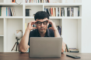 sad depression serious people from work,study stress problem.asian man feeling tired suffering using computer working work place.concept global economic,health problems