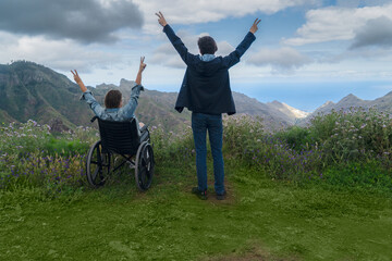 Young man and his wife in wheelchair travelling together by car in mountains