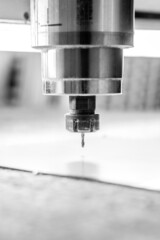 CNC drilling machine is working with metal plate. Close-up