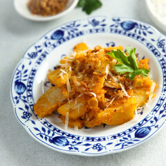 Roasted potato with red pesto and cheese