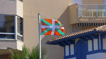 Ikurrina flag, a Basque symbol and the official flag of the Basque Country Autonomous Community of Spain and France, waving in front of a house in Arcachon