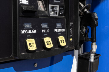 Gas pump dispenser with three qualities of gasoline.