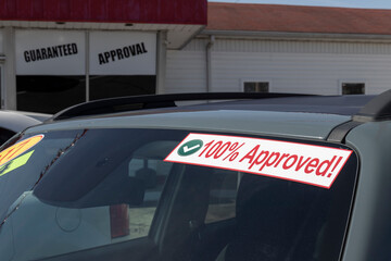100% Approved sign at a Buy Here Pay Here used car lot. Many buy here pay here car dealerships do...