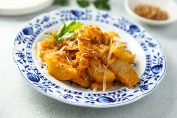 Roasted potato with red pesto and cheese