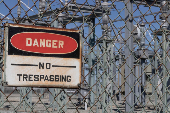 DANGER - NO TRESPASSING sign at an electrical substation.