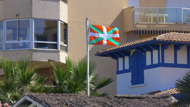 Ikurrina flag, a Basque symbol and the official flag of the Basque Country Autonomous Community of Spain and France, waving in front of a house in Arcachon
