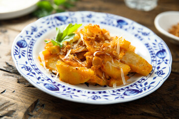 Roasted potato with red pesto and cheese