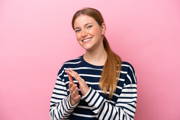 Fototapeta premium Young caucasian woman isolated on pink background applauding after presentation in a conference