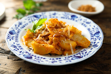 Roasted potato with red pesto and cheese