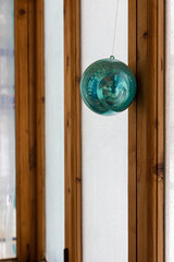 decorative shiny ball hanging on a rope on the wall