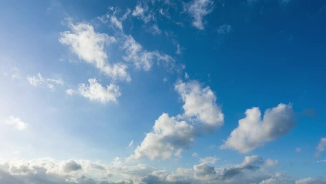 Fast moving white clouds on the blue sky. 4K sky cloud time lapse.