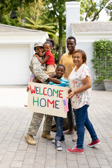 Portrait of happy female mid adult african american soldier with family welcoming her on arrival
