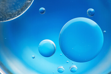 abstract light blue background with oil circles . bubbles of water close up .