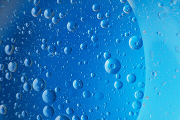 abstract light blue background with oil circles . bubbles of water close up .