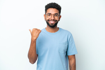 Fototapeta premium Young Brazilian man isolated on white background pointing to the side to present a product