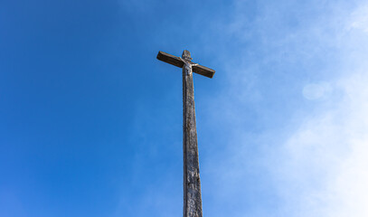 Crucifixion of Jesus Christ against the blue sky.