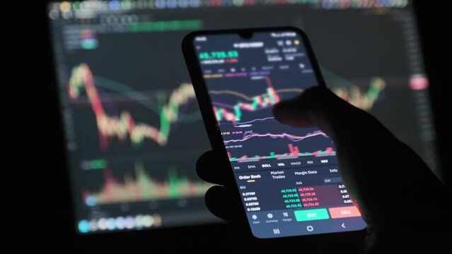 Crypto trading in smartphone. Businessman checking Bitcoin price chart on digital stock exchange mobile phone screen. Cryptocurrency trading. Market trading online, graph of price changes, analytics