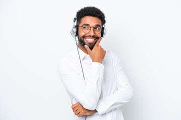 Telemarketer Brazilian man working with a headset isolated on white background smiling