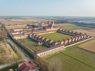 Fototapeta na wymiar Aerial view of the Certosa di Pavia at morning, built in the late fourteenth century, courts and the cloister of the monastery and shrine in the province of Pavia, Lombardia, Italy