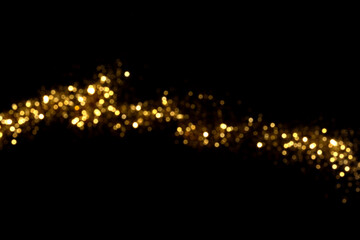 Golden blurred bokeh lights on black background. Glitter sparkle stars for celebrate. Overlay for your design