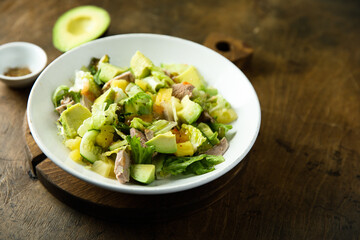 Healthy salad with duck, pineapple and avocado