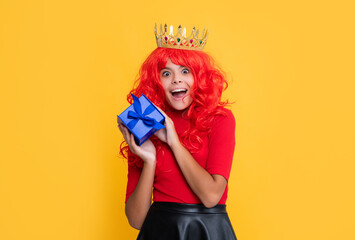 surprised queen crown in crown with present box on yellow background